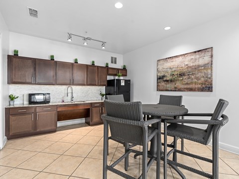 a kitchen and dining area with a table and chairs